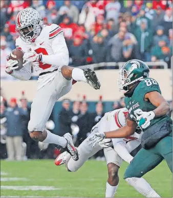  ?? [ADAM CAIRNS/ DISPATCH] ?? Ohio State cornerback Gareon Conley intercepts a pass intended for Michigan State receiver Monty Madaris on Nov. 19, 2016.