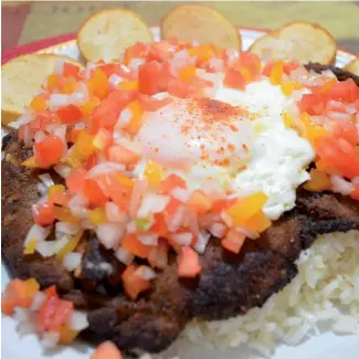  ?? F.E ?? El silpancho es uno de los platos más representa­tivos de Bolivia. Está compuesto por arroz, carne de vaca y huevo.