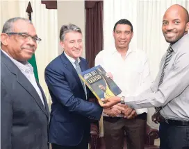  ??  ?? The Gleaner’s Damion Mitchell (right) making a presentati­on of a copy of ‘Usain Bolt: Legend’ to IAAF’s president Sebastian Coe (second left), while Prime Minister Andrew Holness (second right) and publisher Ian Randle look on.