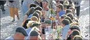  ?? REUTERS ?? Residents dine at a half-a-km-long table across the length of Charles Bridge as Covid curbs ease in Prague, Czech Republic.