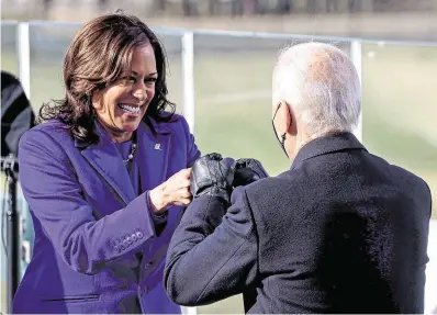  ?? PHOTO: JONATHAN ERNST/ REUTERS ?? Well done: Kamala Harris bumps fists with Joe Biden, after she was sworn in as vice president of the United States in Washington yesterday.