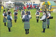  ??  ?? Photograph: Sara Bain. Skye Youth Pipe Band entertain the crowds.