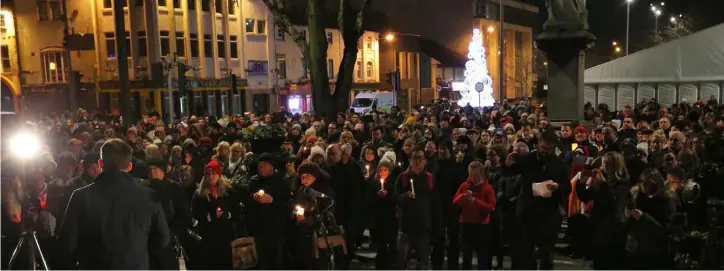  ??  ?? People light candles pictured outside Dundalk Courthouse where a candlelit vigil was held for murder victim Yosuke Sasaki (24) who died in a knife attack on Avenue Road.w