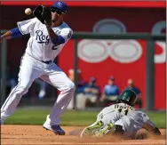  ?? JOHN SLEEZER/ TRIBUNE NEWS SERVICE ?? Oakland Athletics' Rajai Davis steals second before the throw to Kansas City Royals shortstop Alcides Escobar in the third inning on Monday in Kansas City, Mo.