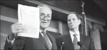  ?? TOM BRENNER / THE NEW YORK TIMES ?? Senate Minority Leader Chuck Schumer, D-N.Y., left, with Sen. Ron Wyden, D-ore., speaks about the Republican tax plan during a news conference Thursday on Capitol Hill.