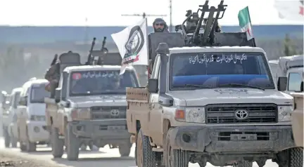  ?? Photo: Reuters ?? Turkish-backed Syrian rebels ride in a truck with a mounted weapon near Manbij, Syria, on December 28, 2018.