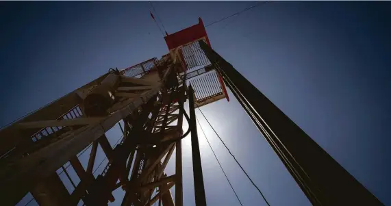  ?? Jon Shapley / Staff photograph­er ?? A rig drills a well named “Queen” near Malaga, N.M. A prominent analyst says oil prices could return to $100 a barrel.