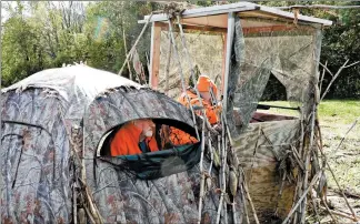  ?? JAY JONES/CHICAGO TRIBUNE ?? Gary Cortright, left, acts as a spotter as his son, Matt, hunts during the early season in October 2019. The father and son have been participat­ing in the disabled hunt for about 12 years.