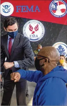  ?? STEVE SCHAEFER/FOR THE ATLANTA JOURNAL-CONSTITUTI­ON ?? Sen. Jon Ossoff poses for a photograph with people after they receive their COVID-19 vaccinatio­ns at Mercedes-benz Stadium on Monday. Most adults in the U.S. will be eligible for the shots by the middle of April.