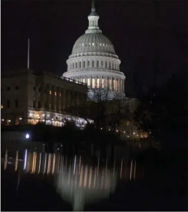  ?? J. SCOTT APPLEWHITE — THE ASSOCIATED PRESS ?? The illuminate­d Capitol Dome is reflected off the top of parked cars before dawn in Washington, Tuesday.