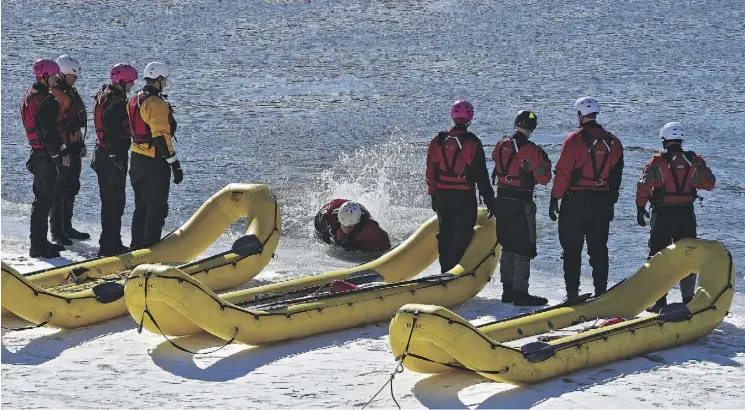  ?? ED KAISER ?? Firefighte­rs from Station 6 practised various forms of rescue as part of their annual swift water ice training exercises along the North Saskatchew­an River across from Rundle Park on Friday. Firefighte­rs conduct between 40 and 70 water-based rescues...