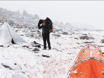  ?? Josh Helling / Special to The Chronicle ?? On a fall wilderness trek above the tree line in Yosemite National Park, Chronicle outdoors writer Tom Stienstra packed up to trek amid the season’s first snowfall.