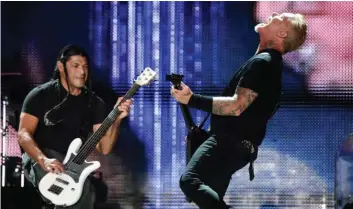  ??  ?? Robert Trujillo, left, and James Hetfield of Metallica perform during their concert at The Rose Bowl on Saturday in Pasadena, Calif. —AP