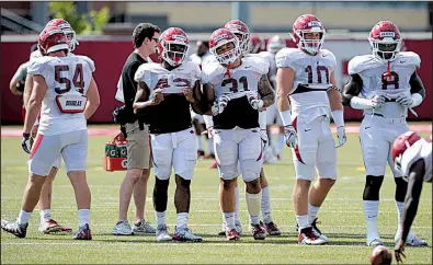  ?? NWA Democrat-Gazette/ANDY SHUPE ?? Linebacker depth has been an issue for the Arkansas Razorbacks in previous seasons, but Bumper Pool (second from right) said there’s reason to be optimistic about the position this season. “I think we’re going to surprise people,” Pool said. “I think we’ve got a good group and we have guys that are just young but they have the talent.”