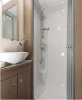  ??  ?? LEFT Washrooms aren’t always this stylish… ABOVE The fully lined shower cubicle has a chrome upriser; bi-fold doors make access easy