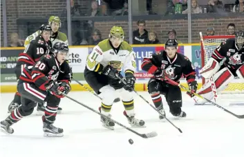  ?? DAVE DALE/POSTMEDIA NETWORK ?? First-period action between North Bay Battalion and Niagara IceDogs at Memorial Gardens in North Bay Friday.