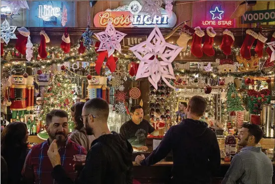  ?? NICK WAGNER / AMERICAN-STATESMAN ?? Holiday decoration­s set the mood at Donn’s Depot. Staff and patrons deck the halls the Sunday after Thanksgivi­ng each year.