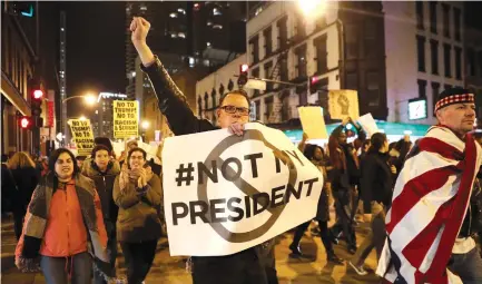  ?? (Armando L. Sanchez/Chicago Tribune/TNS) ?? PROTESTERS MARCH north on State Street in downtown Chicago on Wednesday.