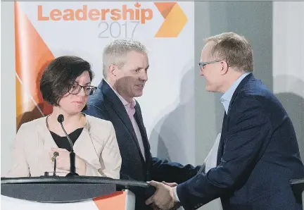  ?? GRAHAM HUGHES/THE CANADIAN PRESS ?? NDP leadership candidate Niki Ashton looks on as fellow candidates Charlie Angus, centre, and Peter Julian shake hands following Sunday’s debate in Montreal. They, along with candidate Guy Caron, attended a meet-the-candidates event in the city Saturday.