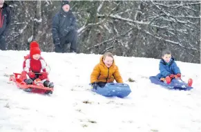  ??  ?? Snow much fun Many children were not complainin­g about the snow, with these youngsters enjoying a sledging race on the slopes of Viewlands Reservoir Park