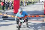 ??  ?? Ed Grazier wins the wheelchair race