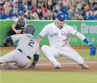 ?? FRED THORNHILL/THE CANADIAN PRESS ?? The Seattle Mariners’ Jean Segura is safe at third base, beating the tag attempt by the Blue Jays’ Josh Donaldson in the fourth inning at the Rogers Centre in Toronto on Thursday.