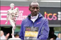  ?? ?? In this file photo, Men’s race winner Kelvin Kiptum of Kenya holds a trophy together with women’s race winner Sifan Hassan, unseen, of the Netherland­s after the London Marathon in London. (AP)