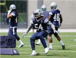  ?? Associated Press ?? n Dallas Cowboys outside linebacker Jaylon Smith runs through a drill during an NFL football practice June 13 at the team's training facility in Frisco, Texas. Smith was mostly hidden from view rehabbing a knee injury during his first training camp...