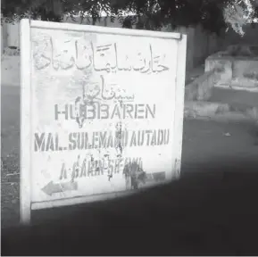  ??  ?? Signpost indicating the site of the tomb of Malam Suleiman Autadu, one of the saints who lived before the coming of Danfodiyo to Sifawa.