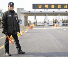  ??  ?? A South Korean security guard stands guard on an empty road which leads to the Kaesong Industrial Complex (KIC) at the South’s CIQ (Customs, Immigratio­n and Quarantine), just south of the demilitari­sed zone separating the two Koreas, in Paju, South...