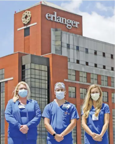  ?? STAFF PHOTO BY C.B. SCHMELTER ?? Critical care nurses, from left, Tracy Headrick, Cody Sims and Victoria Hunter pose at Erlanger Hospital on Thursday.