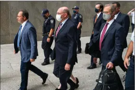  ?? (AP/Craig Ruttle) ?? The Trump Organizati­on’s Chief Financial Officer Allen Weisselber­g (center) leaves after a courtroom appearance Monday in New York.