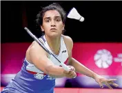  ?? AFP ?? P. V. Sindhu hits a shot against Taiwan’s Tai Tzu-ying during their women’s singles first round match at the World Tour Finals badminton tournament in Bangkok on Wednesday. Tai won 19-21, 21-12, 21-17. —