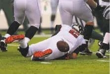  ?? Ed Mulholland / Getty Images ?? Atlanta quarterbac­k Matt Ryan fumbled four snap exchanges on a rainy day in East Rutherford, N.J. The Jets recovered two.