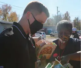  ?? Submitted photo ?? ■ Entergy Arkansas volunteers Jason Oliver, left, with Arkansas Nuclear One and Leticia Finley with Transmissi­on put together boxes of frozen meals, canned goods and shelf-stable items as part of an event with the Arkansas Food Bank in November 2020 to serve veterans in the Russellvil­le area.