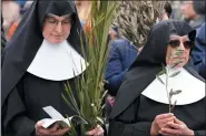  ?? (AP Photo/Andrew Medichini) ?? FILE - Nuns wait for the start of the Palm Sunday’s mass celebrate by pope Francis in St. Peter’s Square at The Vatican Sunday, April 2, 2023. Palm Sunday will be celebrated by Christians worldwide Sunday, March 24, 2024. It commemorat­es the Christian belief in the triumphant entry of Jesus into Jerusalem, when palm branches were strewn before him. It marks the start of Holy Week.