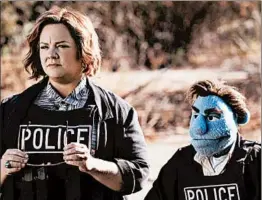  ?? STX ENTERTAINM­ENT ?? Melissa McCarthy as a detective re-teams with her puppet partner to look into killings.