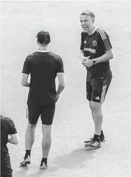  ??  ?? Inter Miami soccer team coach Phil Neville (right), shares with staff members. PEDRO PORTA/ THE MIAMI HERALD