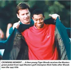  ??  ?? CROWNING MOMENT . . . A then young Tiger Woods receives the Masters green jacket from 1996 Masters golf champion Nick Faldo after Woods won the 1997 title
