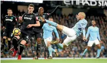  ?? CLIVE BRUNSKILL ?? A spectacula­r strike by David Silva earns Manchester City a 2-1 win over West Ham.