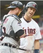  ?? Autey, AP) (Photo by John ?? Minnesota Twins hitter Joe Mauer, right, hopes to lead his team to a win tonight over the New York Yankees.