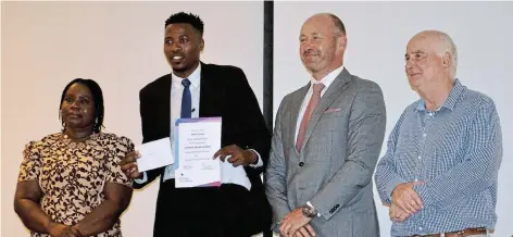  ?? JON HOUZET Picture: ?? WELL-DESERVED; Africa Tshezi, second from left, is presented with the Raymond Mhlaba Award for tenacity, perseveran­ce and diligence at the Stenden South Africa academic opening and awards ceremony held on Monday. With him are hotel management school dean Dr Juliet Chipumuro, executive dean Dr Wouter Hensens and disaster management school dean Dr Des Pyle