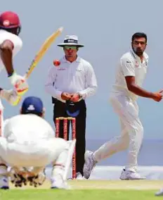  ?? AP ?? India’s Ravichandr­an Ashwin (right) produced an impressive spell to dismiss West Indies in the second innings at the Sir Vivian Richards Stadium on Sunday.