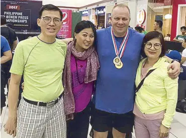  ??  ?? Author James Michael Lafferty with wife Carol and family at the recent Philippine Bench Press National Championsh­ips