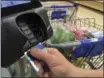  ?? ELISE AMENDOLA — THE ASSOCIATED PRESS FILE ?? A customer buys groceries with a credit card.