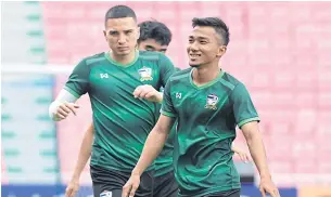  ??  ?? Midfielder Chanathip Songkrasin, right, and defender Tristan Do during a training session yesterday.