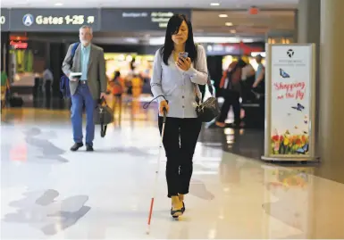  ?? Photos by Gene J. Puskar / Associated Press ?? Chieko Asakawa, above, uses the airport wayfinding app, below, that she and her team at Carnegie Mellon University developed to navigate through a Pittsburgh Internatio­nal Airport terminal for a flight to Japan.