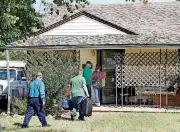  ?? [PHOTO BY JIM BECKEL, ?? Family members and relatives of Magdiel Sanchez enter the family home around noon on Wednesday. An Oklahoma City police officer is on paid administra­tive leave after he shot and killed Sanchez on Tuesday night in front of this house in south Oklahoma...