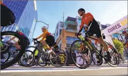  ?? ?? Cyclists riding for Padres Pedal the Cause take off on the 55-mile bike ride, which started on the corner of J Street and Eighth Avenue just outside Petco Park.