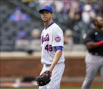  ?? JOHN MINCHILLO - THE ASSOCIATED PRESS ?? New York Mets starting pitcher Jacob deGrom (48) walks off the field after striking out Miami Marlins’ Jesus Aguilar in the first inning of a baseball game, Saturday, April 10, 2021, in New York.